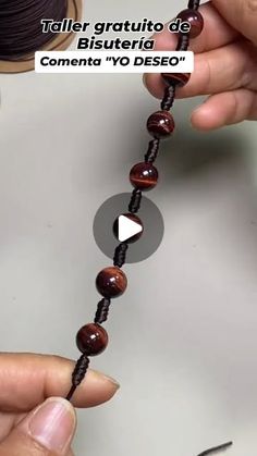 someone is making a bead necklace with beads