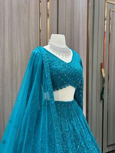 This Teal Bridal Lehenga BL-099 offers a stunning and elegant look for any bride's special day. Made with high-quality materials, it provides comfort and durability. The rich teal color adds a regal touch while the intricate design showcases traditional craftsmanship. Perfect for capturing unforgettable moments. Fabric: Net with Satin Silk Lining! WASH CARE INSTRUCTIONS - Please Dry clean only when it is applicable! Ready to Ship! Elegant Look, Teal Color, Satin Silk, Bridal Lehenga, Teal Colors, Intricate Design, Showcase Design, Silk Satin, Lehenga