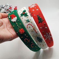 three christmas themed headbands are held in the palm of someone's hand