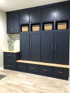 an empty room with blue cabinets and baskets