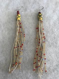 This is an elegant  and unique beaded earring made of African beads in Bohemian style!  Length is approx between 5-6"inches.  Buy any 3 beaded pairs for $25. Please message me first with you choice of 3.  Please note that colors in pictures may appear to be a little different from the actual earring. Elegant Dangling Beads For Festival, Unique Adjustable Beaded Earrings With Dangling Beads, Bohemian Beaded Earrings With Gold Beads For Party, Festival Earrings With Gold Beads, Adjustable Long Drop Beaded Earrings With Dangling Beads, Bohemian Gold Beaded Earrings For Party, Elegant Beaded Earrings For Festival, Bohemian Long Drop Earrings With Colorful Beads, Colorful Long Drop Beaded Earrings With Adjustable Fit