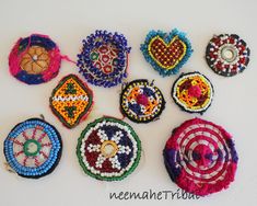 a group of beaded objects sitting on top of a white table next to each other