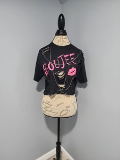 a mannequin wearing a black shirt with pink lipstick on it