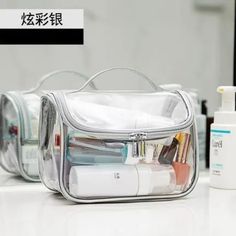 an open clear cosmetic bag sitting on top of a counter next to bottles and containers