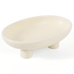 a white bowl sitting on top of a wooden stand