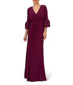 a woman in a long purple dress with sleeves on her shoulders and an open v - neck