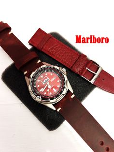 Title; RARE Marlboro wrist watch/ Great vintage condition/ Real Handmade Leather Strap watchband/ Very nice collectible item/Works very well ✔️ ✈🎁 Fast shipping UPS Express (Europe 2-3 days) (America 3-5 days) (Australia 5-8 days) (Canada-4-8 days) CUSTOM handmade leather strap  ✔️Real handmade leather strap  ( Special edition ) ✔️Leather  Replacement cord ✔️  Beautiful Red DİAL  ✔️Titanium case 🎁🎁VERY STYLISH AND ELEGANT🎁🎁 Vintage Marlboro wrist watch, can be used by both men and women. 19 Red Leather Quartz Watches, Classic Red Watch With Leather Strap, Red Leather Watch With Round Dial, Red Leather Watch Accessories With Round Dial, Vintage Brown Watches With Leather Strap, Vintage Brown Watch With Leather Strap, Vintage Brown Leather Strap Watch Accessories, Vintage Leather Watch Bands For Formal Occasions, Red Automatic Watch Accessories For Gifts