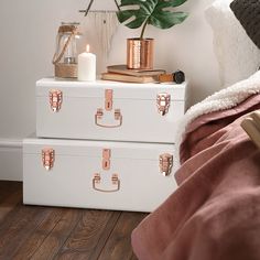 two pink suitcases stacked on top of each other in front of a white wall