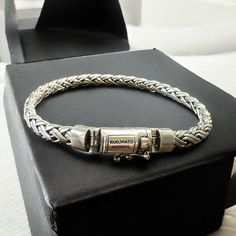 This beautiful bracelet is made of high-quality sterling silver 925, perfect for those who appreciate handcrafted artisan jewelry. The double weave style and box claps make it a unique and stylish piece, while the oval shape and braided chain type give it a touch of elegance. The bracelet is nickel-free and comes in a 5 mm width, making it suitable for both men and women. It is a perfect addition to any jewelry collection and can be worn for any occasion. Made in Indonesia, this bracelet is a must-have for anyone who loves silver jewelry. Bracelet Description Length: 7.75"/19.5 cm, 8.25"/21 cm, 8.75'/22 cm Width: 5 mm Thickness: 4 mm Weight:  7.75"-30 grams                8.25"-32 grams                8.75"-33 grams Sterling Silver Braided Bracelet With Silver Clasp Gift, White Gold Sterling Silver Braided Bracelet For Gifts, White Gold Sterling Silver Braided Bracelet As Gift, Classic Sterling Silver Braided Bracelet With Engraving, Classic Engraved Sterling Silver Braided Bracelet, White Gold Jubilee Braided Bracelet As A Gift, Classic Silver Braided Bracelet With Box Chain, Classic Sterling Silver Braided Bracelet As Gift, Classic Braided Bracelet With Sterling Silver Clasp