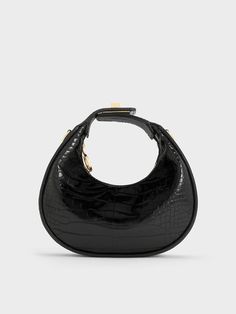 Look no further than this croc-effect moon bag for a chic handbag to add to your collection. The sleek black croc-effect finish adds subtle textural interest to the moon bag silhouette, creating a visually appealing exterior that is timeless yet contemporary. Gold-toned hardware like the turn-lock detail on the top handle elevates the minimal design with a luxurious element. You can opt to carry it by its top handle, or attach the strap to turn it into a posh shoulder bag. Charles And Keith, Bag Silhouette, Chic Crossbody Bag, Moon Bag, Size Chart For Kids, Mary Jane Pumps, Bags Shop, Women Bags Fashion, Charles Keith