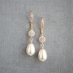 "* Beautiful gold wire wrapped Swarovski Pear Pearl dangle earring accented with a gold-filled bead cap and complimented a cubic zirconia center piece bead and hung from a cubic zirconia ear wire. This pair of earrings measure approximately 1 3/8\". * Also, available in Swarovski Pearls ~ White (shown), Cream (shown), Cream Rose, Light Gold, and Rose Gold. * Matching bracelet (shown in the 5th picture)~ https://www.etsy.com/listing/783225489/wedding-jewelry-for-brides-swarovski * TAKE 10% OFF $7 Wedding Dangle Earrings, Gold Earrings Long, Pearl Earrings Long, Pearl Gold Earrings, Bridal Party Earrings, Bridesmaid Gifts Earrings, Wedding Jewelry For Bride, Crystal Wedding Jewelry, Gold Dangle Earrings