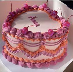 a cake decorated with pink and orange icing