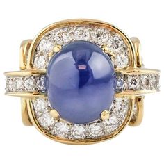 Step into a world of celestial elegance with the Tiffany & Co. Donald Claflin Star Sapphire and Diamond 18k Gold Platinum Ring. This extraordinary piece, bearing the legacy of both Tiffany & Co. and the renowned designer Donald Claflin, is a testament to artistry, luxury, and the enchanting allure of rare gemstones. Crafted with unparalleled expertise, this ring showcases an exquisite 18k gold band with platinum accents, a hallmark of Tiffany's commitment to excellence. At its center, a mesmeriz Sapphire Cabochon, Vintage Cocktail Ring, Fine Diamond Jewelry, Tiffany Jewelry, Star Sapphire, Sapphire Diamond Ring, Vintage Cocktail, Buying Diamonds, Tiffany And Co