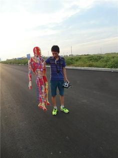 a man standing next to a woman dressed in colorful clothing