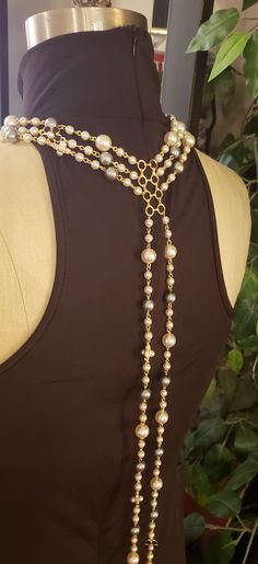 Description: Beautiful unique multi strand pearl necklace featuring beautiful black and white enameled floral motifs. What woman doesn't deserve her own Pearls? Really adds flare to that 'little Black Dress" Limited Edition Item Details: 4 connected strands measuring " " respectively. Ships within 3-5 days Long Pearl Pendant Necklace For Parties, Long Pearl Chain Necklace For Party, Long Pearl Necklace With Pearl Chain For Party, Long Pearl Necklace For Party, Pearl Lariat Necklace For Party, Long Pearl Necklace With Pearl Charm For Party, Long Single Strand Pearl Necklace For Party, Elegant Pearl Pendant Backdrop Necklace For Party, Lariat Pearl Necklace With Charm For Parties