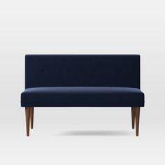 an upholstered couch with wooden legs and dark blue fabric, on a white background