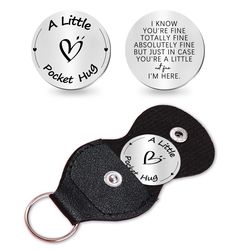 two black and white keychains with words on them, one saying i love you