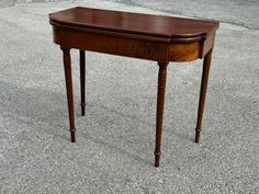 a small wooden table sitting on top of cement