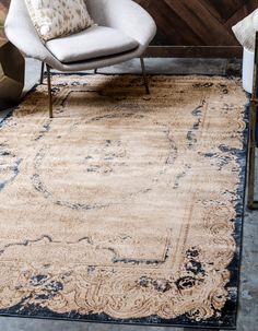 a large rug with an ornate design on the front and back sides in blue tones