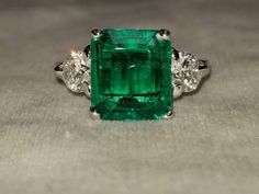 GORGEOUS 14K white gold emerald  engagement ringcenter Lab Flux Growth EMERALD COLOMBIA BERYL EMERALD weight 3.18ct. size 10.7X9.4X3.9mmnice vivid green color ,clean, very lively ,nice cut .side two round diamonds total weight 0.85ct H-SI1Ring SIZE 6.5Resizable Retail value $8,500 net.Cert Appraisal available Gia Certified Green Asscher Cut Diamond Ring, Radiant Cut Green Emerald Ring In Platinum, Platinum Emerald Ring With Radiant Cut, Gia Certified Green Emerald Ring In Platinum, Gia Certified Green Emerald Platinum Ring, Green Asscher Cut Diamond Ring In Platinum, Gia Certified Green Princess Cut Diamond Ring, Green Emerald Cut Platinum Rings, Green Platinum Ring With Emerald Cut