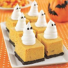 there are many desserts on the plate with white frosting and ghost hats on them