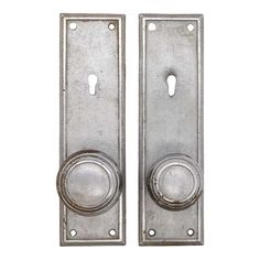 two metal door handles with knobs on each side