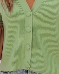 Relaxed Fit 50% Viscose. 28% Polyester and 22% Nylon Hand Wash Cold V-Neckline Long Sleeves Front Fabric Button Closures Not Lined We're all about bold this fall! Our Yganico Button Front Crop Knit Cardigan comes in a bright mint green hue. Designed with front fabric button closures and a v-neckline. Styled with the Carson Black Frame Dark Smoke Polarized Sunglasses. Perfect Hoop Earrings. Gaia Coin Necklace. Mica Chain Choker Necklace. Chic Crossbody Chain Pouch Bag. Kason Distressed High Rise Trendy Green V-neck Sweater For Spring, Spring V-neck Sweater With Button Closure, Trendy V-neck Sweater For Spring Workwear, Knit V-neck Cardigan With Buttons, Green Knit Cardigan With Buttons, Green V-neck Cardigan For Day Out, Trendy V-neck Outerwear With Button Closure, Green V-neck Cardigan For Work, Spring V-neck Outerwear With Button Closure