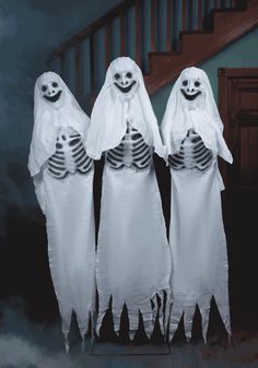 three ghost costumes standing next to each other