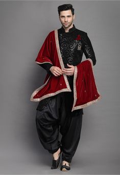 Velvet Sherwani in Black This Readymade attire is Enhanced with Buttons, Resham, Sequins and Beads Work. Crafted in Chinese Collar Neck and Full Sleeve Available with a Satin Crepe Salwar  in Black Do note: Brooch, Dupatta and Footwear shown in the image is for presentation purposes only. Half to one inch may vary in measurement. In case you want to purchase the Dupatta (WEBSITE ITEM CODE: MXX298). (Slight variation in actual color vs. image is possible) Embroidered Churidar For Ceremonial Occasions, Anarkali Sherwani For Festive Traditional Ceremonies, Festive Anarkali Sherwani For Traditional Ceremonies, Anarkali Style Sherwani For Diwali Ceremonies, Anarkali Style Sherwani For Diwali, Ceremonial Anarkali Salwar Kameez For Eid, Anarkali Sherwani With Pallu For Traditional Ceremonies, Traditional Black Bandhgala With Resham Embroidery, Anarkali Sherwani With Zari Work For Traditional Ceremonies