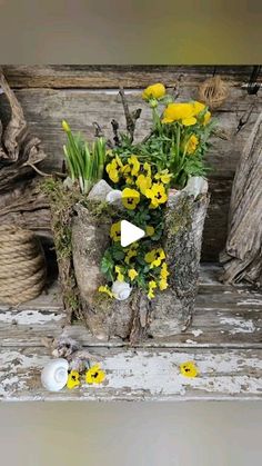 yellow flowers are sitting in an old wooden bucket