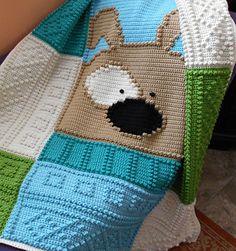 a crocheted blanket with a dog on it