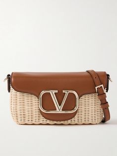 Part of Valentino Garavani's 'Locò' collection, this shoulder bag is woven from raffia, making it perfect for warmer months. It's trimmed with smooth leather and accented with the signature 'VLOGO'. Stow a couple of lipsticks, your phone and a cardholder inside. Designer Straw Bag With Gold-tone Hardware, Luxury Rectangular Straw Bag With Detachable Strap, Luxury Natural Shoulder Bag For Shopping, Luxury Straw Bag With Leather Handles For Evening, Designer Beige Straw Shoulder Bag, Designer Woven Straw Shopping Bag, Luxury Evening Straw Bag With Leather Handles, Luxury Rectangular Straw Bag, Designer Natural Shoulder Bag For Shopping