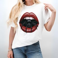 Unleash your dark, edgy side with our "Spider Kiss" tee, featuring a striking design of bold red lips with a black spider crawling out. This graphic tee merges gothic allure with a hint of danger, making it a standout piece in any wardrobe. Crafted on the Comfort Colors 1717 t-shirt, this piece combines unmatched softness with lasting durability, perfect for those who value both style and comfort. The garment-dyed fabric offers a unique, lived-in look and feel, ensuring each shirt is as distinct Trendy Red Top For Halloween, Edgy White T-shirt For Fall, Edgy Halloween T-shirt With Sublimation Print, Edgy T-shirt With Sublimation Print For Halloween, Red Crew Neck Top For Halloween, Red Graphic Print Shirt For Halloween, Red Shirt With Graphic Print For Halloween, Red Halloween T-shirt With Graphic Print, Punk Red T-shirt For Halloween