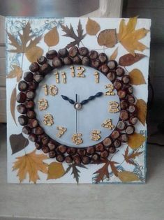 a clock made out of wine corks with leaves on the sides and numbers carved into it