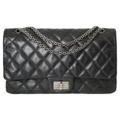 This Chanel Reissue 2.55 Double Flap Bag is skillfully made with aged calfskin, presenting a classic black quilted pattern and striking silver hardware.  Made of 100% black calfskin leather, this bag boasts a turn-lock closure, double flap design, one main compartment with two interior pockets, a smaller compartment, and an exterior pocket Please note that this bag is a pre-owned item in very good condition. Please refer to the images for references. Classic Bags With Double Flap And Silver-tone Hardware, Classic Shoulder Bag With Silver-tone Hardware And Double Flap, Chanel Reissue, Quilted Pattern, Black Quilt, Flap Bag, Silver Hardware, Fashion Handbags, Classic Black