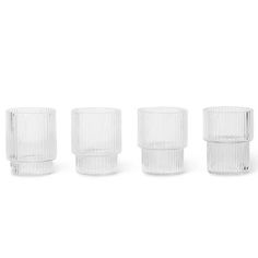 four clear glass tumblers lined up in a row