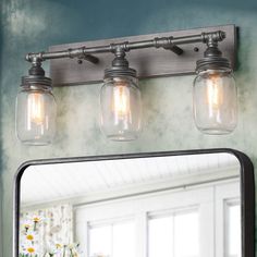 a bathroom vanity with two lights and a mirror