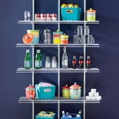 a shelf filled with lots of food and drinks on top of blue walls in a room