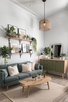 a living room filled with furniture and lots of plants on the wall above it's coffee table