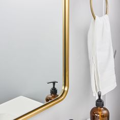 a bathroom with a sink, mirror and soap dispenser