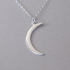 "Polished sterling silver crescent moon pendant necklace. Pendant (mm): 31 x 10 x 1 Chain: sterling silver flat cable chain available in 16\" and 18\" Also available in gold: https://www.etsy.com/listing/157765641/gold-crescent-moon-necklace Let's keep in touch, sign up for our newsletter and receive 15% off your first order https://lp.constantcontact.com/su/Dpyaymg" Dainty Fine Jewelry, Crescent Pendant, Crescent Moon Necklace Silver, Moon Necklace Silver, Crescent Moon Pendant, Moon Pendant Necklace, Diamond Solitaire Necklace, Pearl Jewelry Necklace, Crescent Moon Necklace