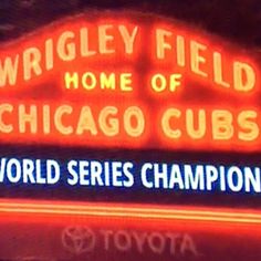 the wrigley field home of chicago cubs world series champion sign is lit up