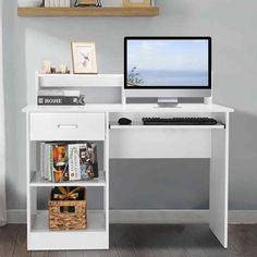 a desk with a computer on top of it and bookshelves above the desk