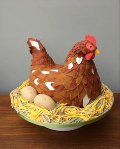 a cake made to look like a chicken sitting in a nest with eggs on it