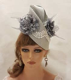 SilverGrey Hat Fascinator with Feathered Flowers, perfect for Royal Ascot, Kentucky Derby, Weddings Goodwood revival, Christening, Ascot or any special occasion. Gorgeous  Silver grey straw weave Hat fascinator with  SilverGrey Silk flowers adorned with a beautiful Leaf motif to the front  **Do you like to have this in any other custom colours, Please message. if possible with the dress picture* This hat has been made by hand and very light to wear. This hat is designed to be worn tilted on the side of the head with  long  Quill feather and the Flowers with feather detail for a beautifull Glamorous look. Attachment option: Alice band (BY DEFAULT HEADBAND WILL BE BLACK SATIN COVERED. IF YOU LIKE TO HAVE IN BROWN,BEIGE/CREAM, SILVERGREY OR OTHER COLOURS PLEASE ADD A NOTE AT CHECKOUT) Groom Hat, Grey Fascinator, Mother Of Groom, Hat Fascinator, Goodwood Revival, Satin Noir, Floral Hat, Alice Band, Leaf Motif