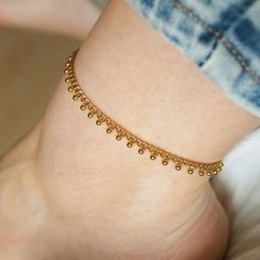 Gold woman anklet with dangling beads, made of stainless steel. 100% handmade ..:: Materials ::.. Stainless steel chain Stainless steel lobster clasp and extender chain ..:: Packaging ::.. Anklet comes on a cardboad card in transparent bag Each size comes with a 5cm (2 inch) extender chain for adjustment ..:: How to choose a right size ::.. Measure any other anklet you own. Or take a piece of string and put it around your ankle. Then measure the string.  Your measurement most likely will be somewhere between sizes. I suggest that you opt for a smaller size (you still will have 5cm (2 inches) extender). Gold Anklets With Tiny Beads As Gift, Gold Dangle Anklets As Gift, Gold Dangle Anklets For Gift, Dangle Anklets With Adjustable Chain As Gift, Metal Anklet With Adjustable Chain As Gift, Adjustable Dangle Anklets As Gift, Adjustable Metal Anklets As Gift, Metal Dangle Anklets As Gift, Handmade Gold Anklet As Gift