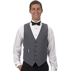 a man in a tuxedo is smiling for the camera