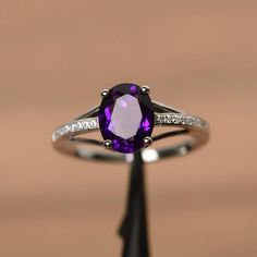 It is a natural amethyst ring. The main stone is 7mm*9mm oval cut, weight about 1.77 carats.The basic metal is sterling silver and plated with rhodium.To change the metal to a solid gold (white/rose) or platinum is also available, please ask for a quotation if you want.You can also go to my shop Home for more elegant rings: https://www.etsy.com/shop/godjewelry?ref=hdr_shop_menuMore rings:https://www.etsy.com/shop/godjewelry?ref=l2-shop-header-avatarCustomization is always welcome and please feel Oval Amethyst Ring In Sterling Silver For Wedding, Formal Oval Amethyst Ring With Cubic Zirconia, Oval White Gold Amethyst Promise Ring, White Gold Oval Amethyst Promise Ring, Oval Amethyst Ring With Cubic Zirconia Accents, White Gold Amethyst Promise Ring With Oval Shape, Oval Amethyst Ring With Cubic Zirconia Accent Stones, Oval Amethyst Ring With Cubic Zirconia And Gemstone Accents, Oval Amethyst Promise Ring In White Gold