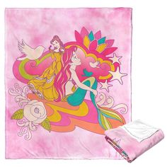 a pink blanket with an image of two mermaids on it