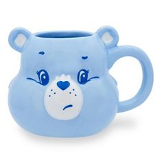 a blue mug with a bear face on it's front and the inside of its mouth